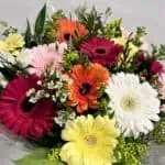 זר פרחים צבעוני במיוחד. שזזור ממגוון גרברות בצבעים שונים כמו אדום, צהוב, ורוד, לבן וכתום. צבע הפרחים משתנה בהתאם למלאי החנות. הפרחים צולמו מקרוב.