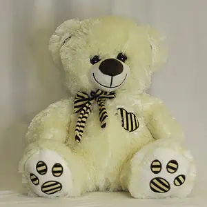 דובי טדי בר בצבע קרם עם פפיון ולב. גובה 50 ס"מ.